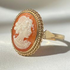 Featuring the art of handcrafted cameos designed & handmade in Italy, following a centuries-old tradition! Featuring the traditional Italian cameo carved by hand from sea shell, with an adjustable band 18kt gold plated silver sterling 925. Available also with a silver band! visit our shop for more matching pieces! Matching necklace available in our shop! Cameo size: 1.5cm X 1cm Ring size: adjustable to fit all adult sizes. Shipping: We offer free Worldwide shipping with Tracking Number. Handmade Vintage Adjustable Cameo Rings, Rose Gold Cameo Jewelry For Gifts, Rose Gold Cameo Jewelry Gift, Victorian Cabochon Rings As Gifts, Victorian Cabochon Rings For Gift, Victorian Cabochon Rings As A Gift, Fine Jewelry Cameo Round Jewelry, Vintage Cabochon Rings For Gifts, Vintage Cabochon Rings As Gift