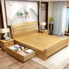 a wooden bed with drawers underneath it in a living room next to a large window