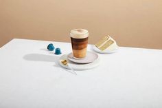 a cup of coffee sitting on top of a white table