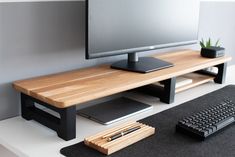 a computer desk with a keyboard, mouse and monitor