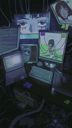 a bunch of computer screens and laptops on a dark surface with wires all over them