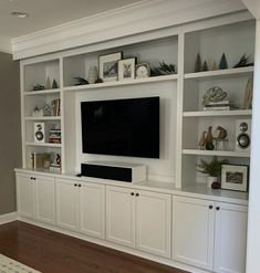 an entertainment center with built - in cabinets and a flat screen tv on the wall