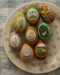 six painted eggs in a bowl on a table