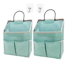 two green storage bags with hooks on them