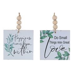 two signs with words on them hanging from the side of each other, one saying do small things with great love