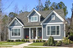 a gray house with white trim and windows