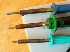 three different types of screwdrivers on a table