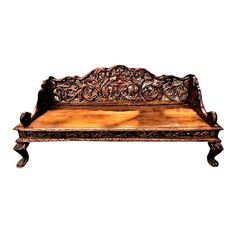 an old wooden bench with carvings on the back and sides, isolated against a white background