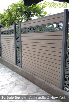 an iron fence is shown on the side of a building with trees in the background