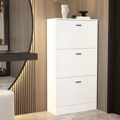 a white cabinet with two drawers in a room