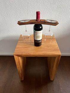 a bottle of wine sitting on top of a wooden table