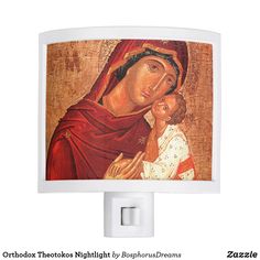 an image of the virgin mary and child jesus night light on a white wall mount