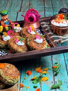 some food is sitting on a wooden tray