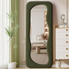 a mirror that is in the middle of a room next to a dresser and chair