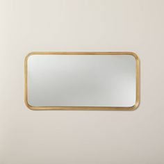 a gold framed mirror against a white wall