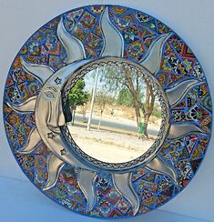 a decorative blue plate with an image of a horse on it's side and trees in the background