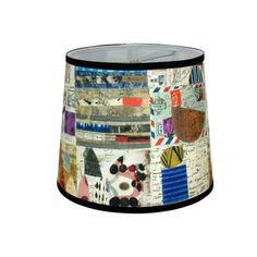 a lamp shade with many different designs and colors on the fabric, it's black frame