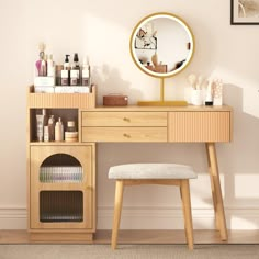 a wooden desk with a mirror, stool and other items on the shelf next to it