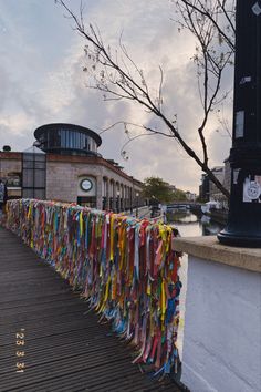 the colorful ribbons are hanging on the fence