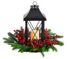 a lit candle is surrounded by pine cones and berries