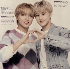 two young men standing next to each other with their hands in the shape of a heart