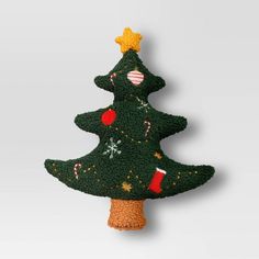 a green christmas tree ornament hanging on a wall