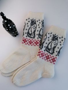 "Wool knitted socks, 100% wool. Unisex model. Medium size. White colour combined with grey cat pattern. Good gift idea for cat lovers. Old knitting traditions from Estonia, knitted on manual knitting machine. Good wool socks for winter period: keeps your feet warm. Please note that knitted socks will stretch later stage. Calf length is rather long. Size 39-40 / US size 8 - food length 9,5\" (24 cm), tube height 9\" (23 cm). Total height 33 cm Food width 4\" (10cm) Calf circ.5\" (12 cm) as upper Knitted Cat, Grey Cat, Cat Socks, Knitted Socks, Knitting Machine, Wool Socks, White Colour, Cat Pattern, Machine Knitting