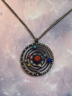 This gorgeous necklace is perfect for any powerful princess from beyond the stars. The large pendant is uniquely jeweled with an array of colorful crystals representing our gorgeous and vast endless solar system. Be the center of the universe in the attention demanding powerful and majestic beauty! Available in two unique and equally gorgeous styles! Solar System Jewelry, Space Necklace, Colorful Crystals, Space Stuff, Space Jewelry, Box Chain Necklace, Bronze Jewelry, Statement Pendant, Gorgeous Necklaces