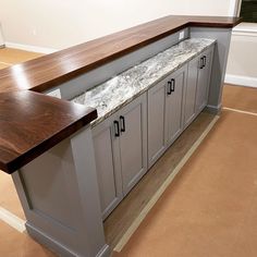 a kitchen island with granite counter tops and cabinets