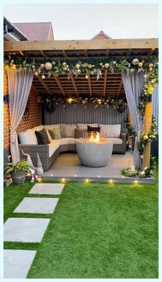 an outdoor living area with grass and lights