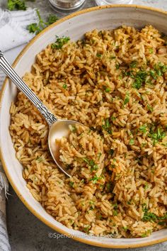 a bowl filled with rice and garnished with parsley