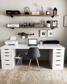 a white desk topped with a laptop computer next to a shelf filled with office supplies