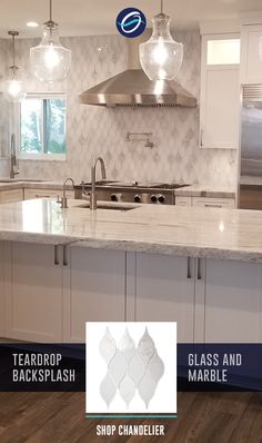 a kitchen with white cabinets and marble counter tops, lights above the sink and stove