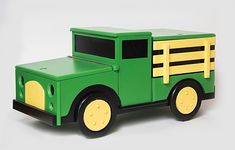 a green and yellow toy truck on a white background