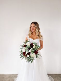 a woman in a wedding dress holding a bouquet