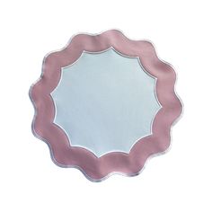 a pink and white paper plate with a circular design on the edge, against a white background