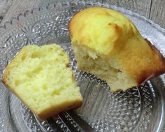 a muffin sitting on top of a glass plate next to a piece of cake