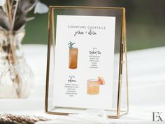 a table with a sign that says signature cocktails and place settings for each guest