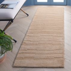 a beige rug on the floor in front of a blue door