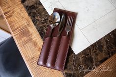 a knife and fork holder sitting on top of a table next to a marble counter