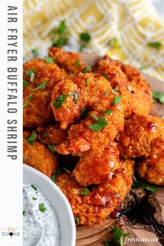 fried chicken wings with ranch dressing on a cutting board