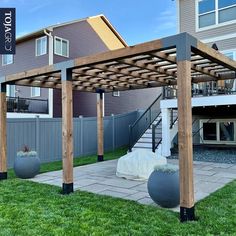 an outdoor patio with wooden pergola and stone steps