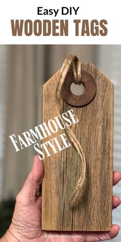 a hand holding a wooden tag with the words farmhouse style on it and an image of a