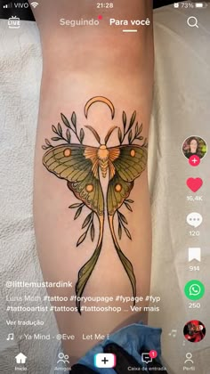 a tattoo on the leg of a person with a butterfly and flowers in its wings