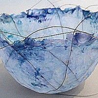 a blue glass bowl sitting on top of a table