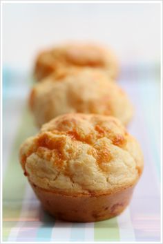 three small muffins sitting on top of a table