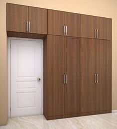 an empty room with wooden cabinets and a white door