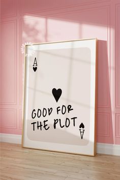 a framed poster with the words good for the plot on it in front of a pink wall