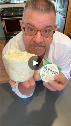 a man holding up a bowl of food