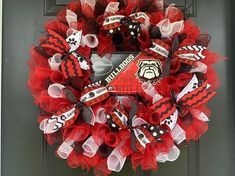 a red and black wreath with hockey decorations on it